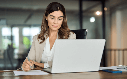 Woman sitting in front of a laptop at the office