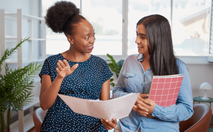 Two women at work having a positive conversation