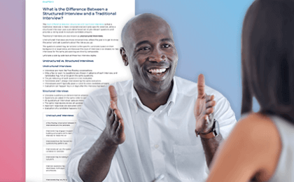 Man interviewing a woman with information about structured interviewing behind him