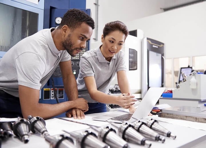 man and woman fixing computer
